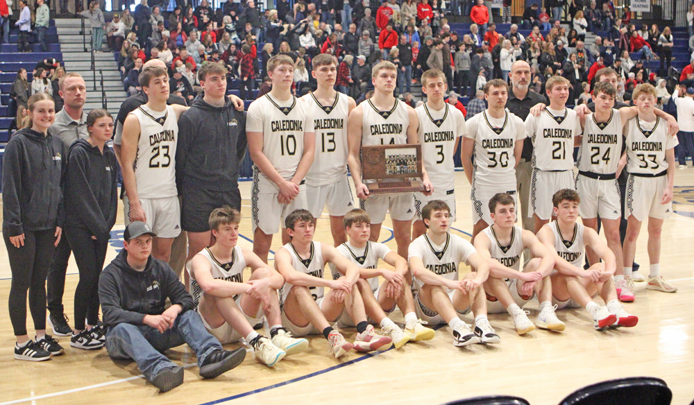A relatively somber bunch of Caledonia Warriors poses with their state Class AA Fourth Place trophy. Team Cal went 1-2 at state, but in each of their losses, they resiliently came back to tie after trailing by 20-plus points. The Warriors finish an excellent year with a 29-4 record. Photo by Paul Trende