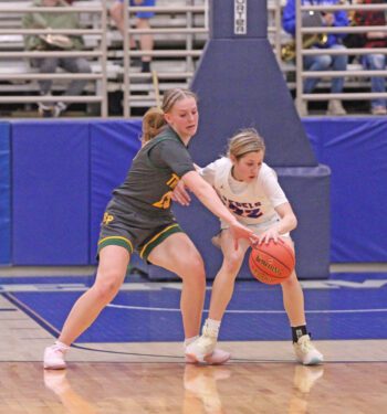 Rushford-Peterson lone senior Nevaeh Happel looks to get the steal from Southland’s Brynlee Koenigs in the teams’ 1A quarterfinal. The Trojans prevailed 58-39 in the game, but then fell to 1-seed, #1 in Class Goodhue 74-51 in the semifinals to finish a good year 17-10. Photo by Paul Trende