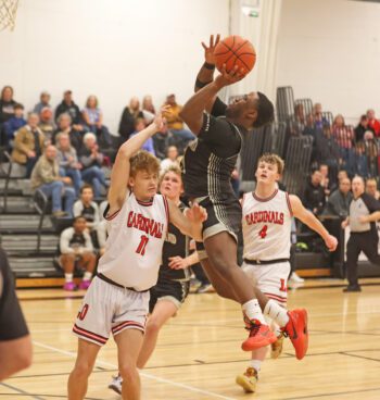 Kingsland’s Kaaleem Reiland flies into LeRoy-Ostrander’s Talon Lewison in the team’ Section 1A Round of 16 contest. The Knights won the rubber match in the series by 65-56 final to move on to Rochester and the 1A quarterfinals. Photo by Christine Vreeman