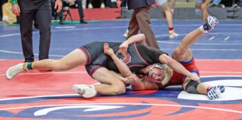 Chatfield’s Ben Carrier battles Kerkhoven-Murdock-Sunberg’s Jett Olson in the state 172-pound third place match. Carrier ended his career beating three ranked foes (including Olson) to finish in third place at state. Photo by Leif Erickson