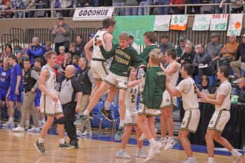 Rushford-Peterson players rejoice after topping previously undefeated Southland 67-61 in a 1A semifinal. Chris Drinkall’s Trojans move on to the Section 1A title game. Photo by Paul Trende