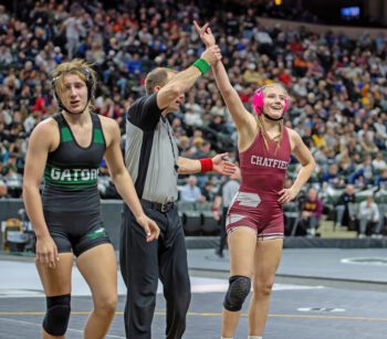 Chatfield’s Elle Eickhoff gets her hand raised in her final match of the season, as she pinned Badger-Greenbush-Middle River’s #2-ranked Madilyn Pulk. Eickhoff, ranked #7 (30-9), thus claimed fifth place on the state stage. Photo by Leif Erickson