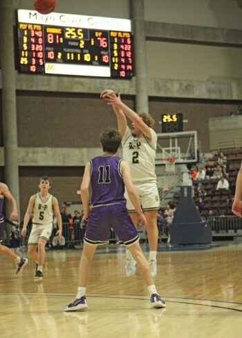 In the waning ticks of the Section 1A title game, Rushford-Peterson’s Jaxson Meldahl lets fly a three that falls, pulling the Trojans to within two at 81-79. But two Luke Roschen free throws subsequently helped sink R-P’s state hopes, as they fell 84-79 in the section title game. Photo by Paul Trende