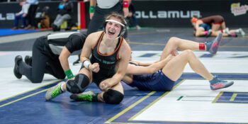 FCLMC’s Charlotte Ferrie is happy after beating Robbinsdale-Cooper’s #8 Anna Delaney by fall in the consolation semifinals. It gave Ferrie the chance to place. The 8th grader (31-8) fell in the fifth-place match to take sixth on the state stage. Photo by Leif Erickson
