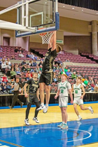 La Crescent/Hokah defenders and Caledonia’s Mason King look on as Garrett Konz throws down the slam in the Warriors 89-47 Section 1AA quarterfinal win at Mayo Civic Arena. Photo by Emma Geiwitz