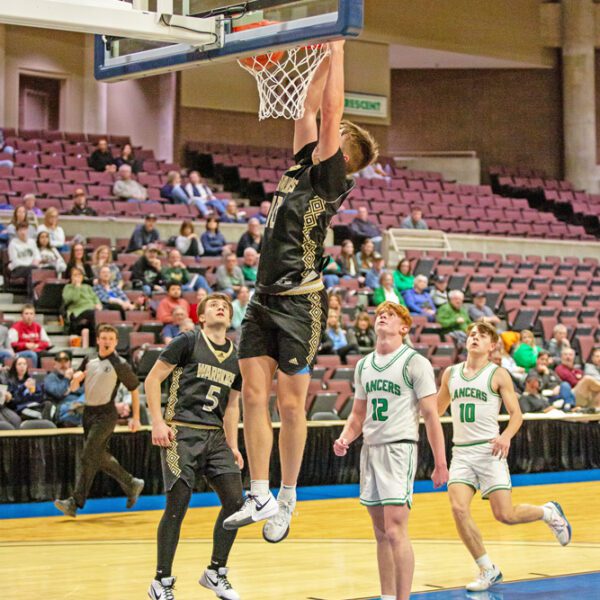 La Crescent/Hokah defenders and Caledonia’s Mason King look on as Garrett Konz throws down the slam in the Warriors 89-47 Section 1AA quarterfinal win at Mayo Civic Arena. Photo by Emma Geiwitz