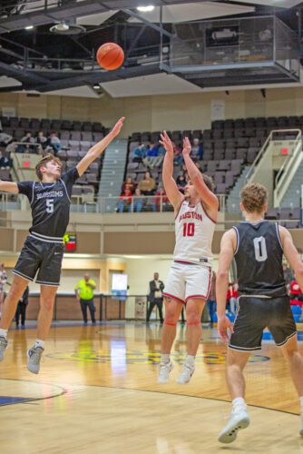 Houston’s Maddox Rodriguez takes the mid-range shot over Blooming Prairie’s Gabe Staloch in the teams’ Section 1A quarterfinal. Houston, in its first trip to Rochester since 2015-2016, bowed out to the Blossoms by 56-45, ending a strong season at 19-9. Photo by Emma Geiwitz