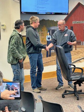 Mayor John McBroom presents a certificate of commendation from the MPCA to WWTF operators Steve Schlichter, left, and Mitch Irish. Photo submitted
