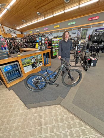 Josie is holding a 24” e-bike with a shorter reach to the handlebars designed for kids from 10-12 years old. Photo by Wanda Hanson