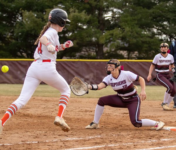 Chatfield’s Grace Finley readies to take the throw to first to get St. Charles runner Willow Lange, while teammate Brittin Ruskell backs up the play, in the Gophers’ season-opener, a 7-2 win. Photo by Leif Erickson