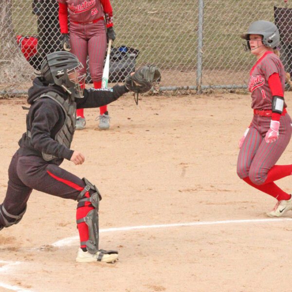 GMLOK catcher Cheyenne Bakken awaits the throw as Houston’s Julia Swenson approaches home plate. The Bulldogs built a 10-4 lead and held off a two-out, seventh-inning Hurricane charge, as GMLOK prevailed 10-9. Photo by Paul Trende