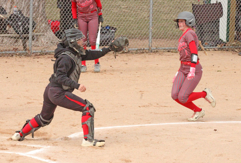 GMLOK catcher Cheyenne Bakken awaits the throw as Houston’s Julia Swenson approaches home plate. The Bulldogs built a 10-4 lead and held off a two-out, seventh-inning Hurricane charge, as GMLOK prevailed 10-9. Photo by Paul Trende