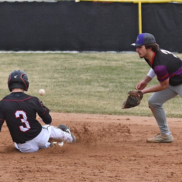 Spring Grove freshman Ezra Konkel steals second base, beating the throw to GMLOK shortstop Blake Hershberger in the Lions’ 10-5 win over the Bulldogs. Photo by Lee Epps
