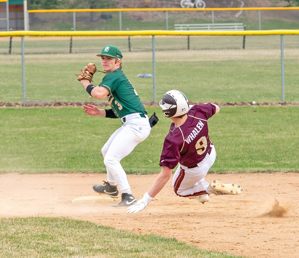 Rushford-Peterson’s Jonah Bunke looks to make the turn to throw for a double-play as Chatfield’s Brody Whalen slides into second base. The Trojans topped the Gophers 4-1 in the game. R-P also beat W-K 9-1, while losing to La Crescent/Hokah 8-2, on the week, Photo by Dawn Hauge