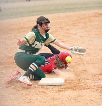 Spring Grove’s Izabel Kaufmann takes a throw to the helmet as Rushford-Peterson’s Delaney Vaughn tries to scoop the ball. Kaufmann was fine and later scored, but R-P posted the 11-3 win in Rushford. Photo by Paul Trende
