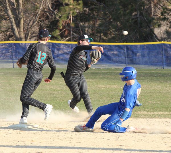 Fillmore Central/Lanesboro’s Joey Pederson fields the ball back of second base, does not get the force at the bag on Mabel-Canton’s Kale Eiken, but does get the out at first. Pederson also got the pitching win as the Falcons topped the Cougars 5-2. Photo by Paul Trende