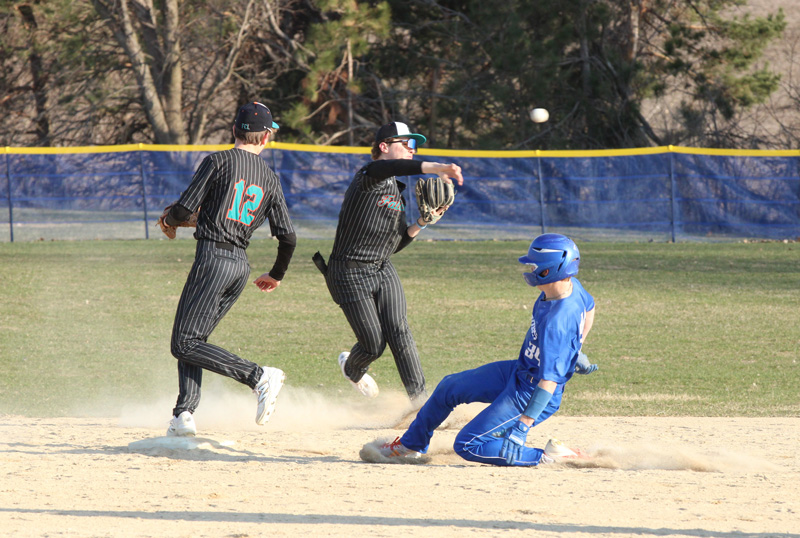 Fillmore Central/Lanesboro’s Joey Pederson fields the ball back of second base, does not get the force at the bag on Mabel-Canton’s Kale Eiken, but does get the out at first. Pederson also got the pitching win as the Falcons topped the Cougars 5-2. Photo by Paul Trende