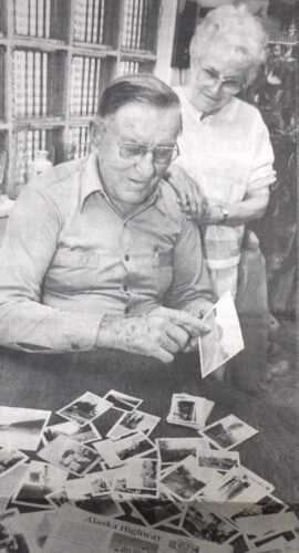 Ed and Millie Lee look through clippings and old photographs from his days working on the Alcan High-way. Photo by Dick Riniker, courtesy of the La Crosse Tribune and the Houston County Historical Society