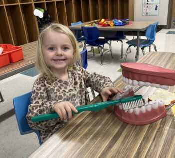 Cora Reidel working on her toothbrushing skills during play time in preschool at R-P Schools. Photo submitted