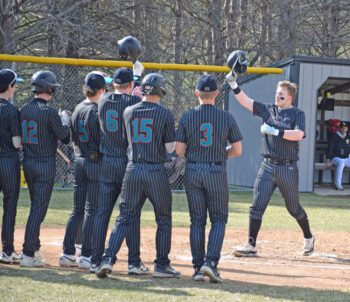 Fillmore Central/Lanesboro’s Levi Rogers approaches home plate and his teammates after hitting a two-run home run versus PEM. The Falcons beat both D-E (13-3 in five innings) and PEM (9-4) to end a year-plus long TRC losing streak, and to improve to 3-3 on the year. Photo by Deb Finseth