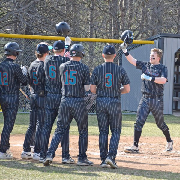 Fillmore Central/Lanesboro’s Levi Rogers approaches home plate and his teammates after hitting a two-run home run versus PEM. The Falcons beat both D-E (13-3 in five innings) and PEM (9-4) to end a year-plus long TRC losing streak, and to improve to 3-3 on the year. Photo by Deb Finseth