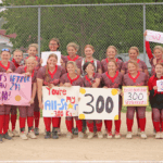 Houston softball poses with teammate Emily Botcher (front row, fourth from left), who amassed her 300th career strikeout in an 8-0 win over Spring Grove (where the senior was a late hit away from a no-hitter). With the win, the Hurricanes also claimed a share of the SEC title with Southland. Photo by Paul Trende
