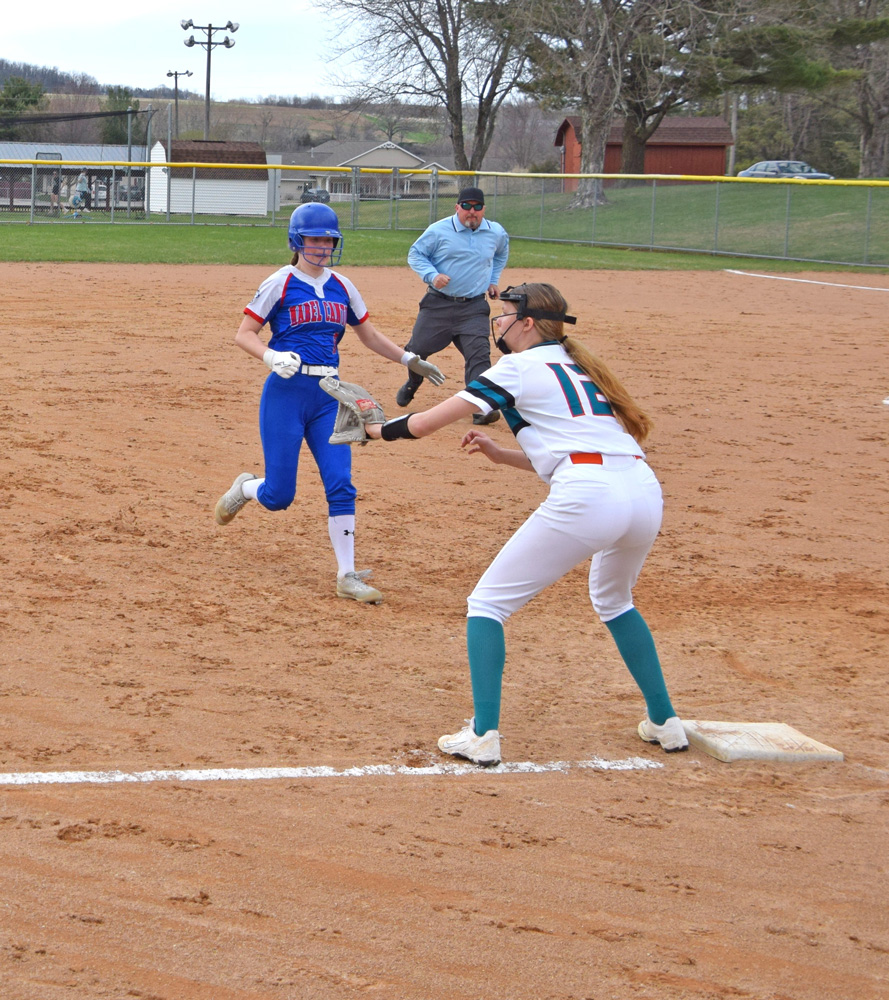 Mabel-Canton’s Tylar Wenthold approaches third base and Falcon Norah Nagel for her triple in the teams’ non-conference game. The Cougars rode a 13-strikeout game from Wenthold to an 8-0 win. Photo by Deb Finseth