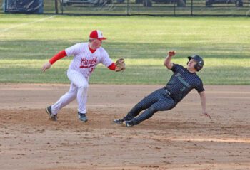 After a botched bunt, Fillmore Central/Lanesboro’s Carter O’Connor finds himself in a pickle with Houston third baseman Coltin Groth. O’Connor was tagged out, but the Falcons came back to beat the Hurricanes 5-3 for FC/L’s fourth straight win. Photo by Paul Trende