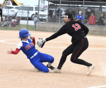 Spring Grove third baseman Brinley Middendorf tags out Mabel-Canton batter/runner Kira Snyder, who had just hit a two-RBI double and attempted to go to third after a play at the plate. The Cougars won the Section 1A opener, 9-4. Photo by Lee Epps