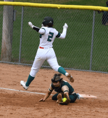 FC/L’s Braelyn Hovey makes it through the bag at first as R-P’s Lindsey Hoiness stretches to make the out. The Trojans swept the teams’ doubleheader, including twice being dead to lose in game two, down 14-4 in the sixth and 14-7 in the seventh (both with two outs), but winning 15-14 in eight innings. Photo by Deb Finseth