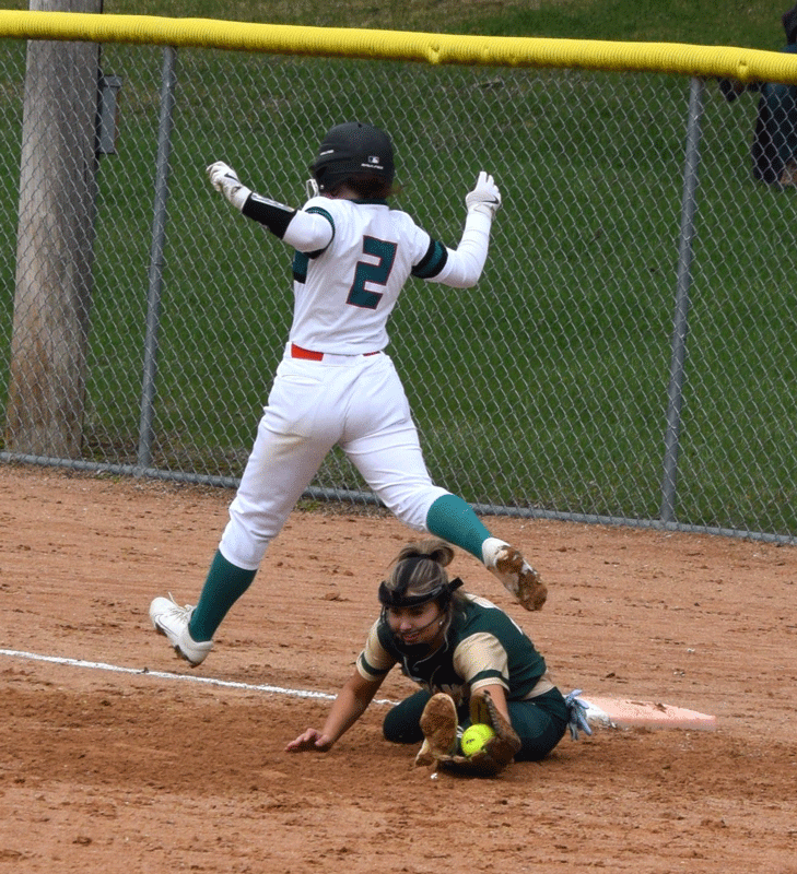 FC/L’s Braelyn Hovey makes it through the bag at first as R-P’s Lindsey Hoiness stretches to make the out. The Trojans swept the teams’ doubleheader, including twice being dead to lose in game two, down 14-4 in the sixth and 14-7 in the seventh (both with two outs), but winning 15-14 in eight innings. Photo by Deb Finseth