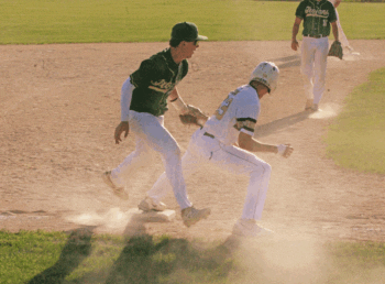 After an infield hit, Rushford-Peterson’s Cayden Lea tries to catch Caledonia’s Jack Schmitz leaning off third base (to no avail). The play was part of a seven-run sixth that led to a 13-3 Caledonia win, as the Warriors (14-6) posted their second straight 4-1 week. Photo by Paul Trende