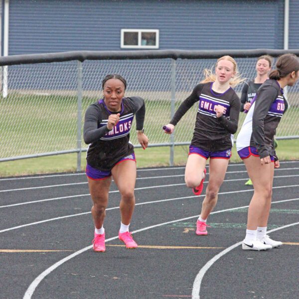 GMLOKS’ Avery Stroup readies to hand the baton to Chantle Reiland for the last leg of the girls 4x100 at the Bulldogs’ home meet. Said team took first, and the GMLOKS girls won their fourth team title of the year. Photo by Paul Trende
