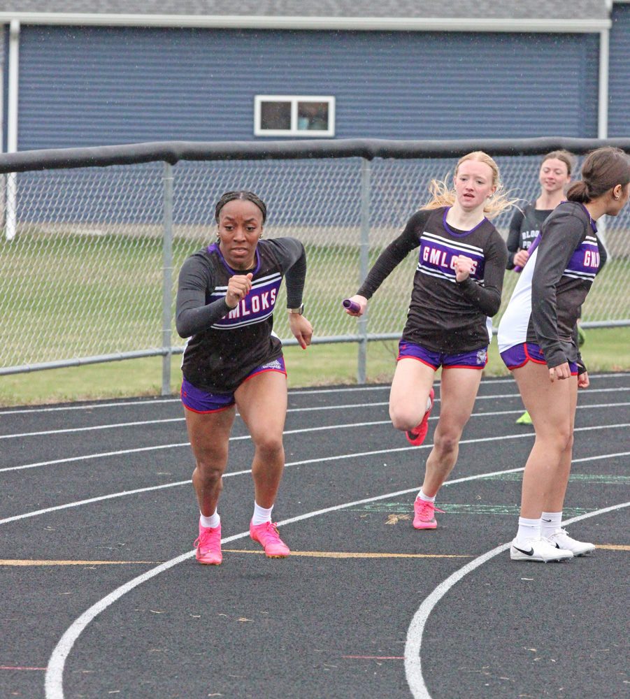 GMLOKS’ Avery Stroup readies to hand the baton to Chantle Reiland for the last leg of the girls 4x100 at the Bulldogs’ home meet. Said team took first, and the GMLOKS girls won their fourth team title of the year. Photo by Paul Trende