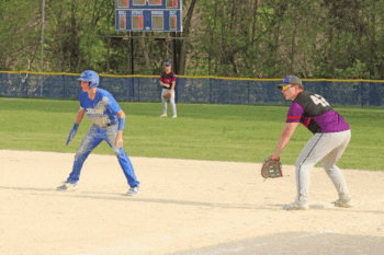 Mabel-Canton’s Nolan Garness takes his lead off first base with GMLOK’s Ira Schmidt holding him on. The Cougars rode a shutout by Darian Hershberger to a 3-0 win in the game, part of a wild week of action for M-C ball teams. Photo by Paul Trende