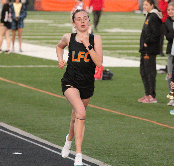 Notching impressive distance performances at the St. Charles meet were LFCMC’s Autumn Rakosnik (left, 11:22.26) and RPH’s Aaron Ploetz (right, 9:49.38). Each took first in the 3,200-meters and each approached a program-record time. Photos by Paul Trende