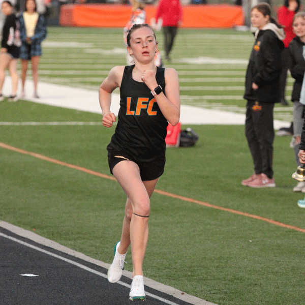 Notching impressive distance performances at the St. Charles meet were LFCMC’s Autumn Rakosnik (left, 11:22.26) and RPH’s Aaron Ploetz (right, 9:49.38). Each took first in the 3,200-meters and each approached a program-record time. Photos by Paul Trende