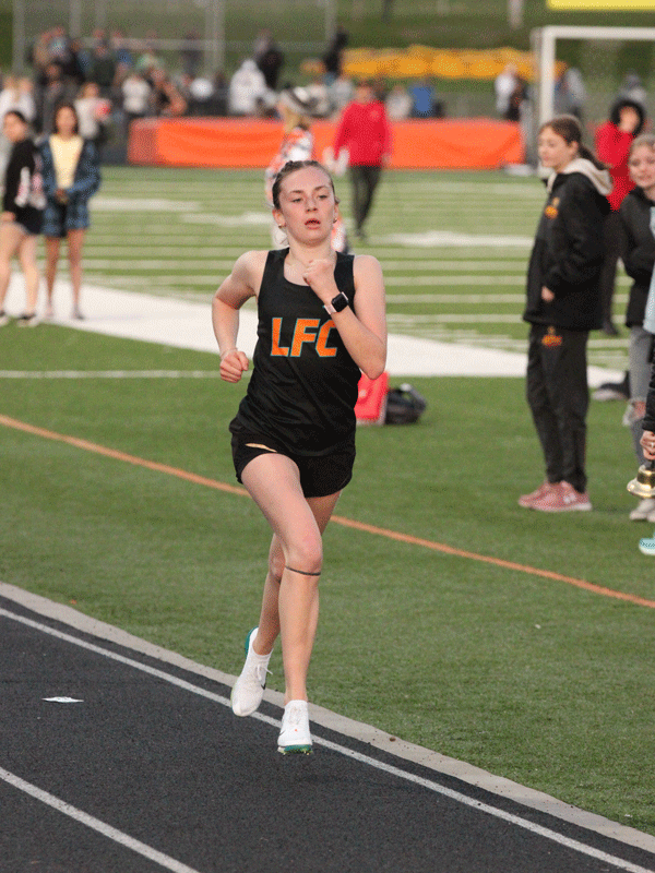 Notching impressive distance performances at the St. Charles meet were LFCMC’s Autumn Rakosnik (left, 11:22.26) and RPH’s Aaron Ploetz (right, 9:49.38). Each took first in the 3,200-meters and each approached a program-record time. Photos by Paul Trende