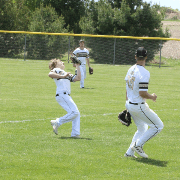 Caledonia second baseman Tanner Ginther goes into foul territory to make a nice play on the ball as teammates Garrett Konz (near) and Mason King (far) are also pictured. Defense and pitching earned Caledonia play-offs wins in their first two games, 4-0 over Lake City, and 8-0 over Randolph. Photo by Paul Trende