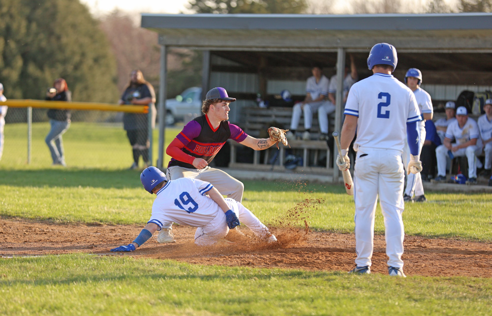 Mabel-Canton’s Kale Eiken scores on a wild pitch in the seventh inning of the Cougars’ game with GMLOK, as Parker Johnson covers home. The Bulldogs led 9-3 heading to M-C’s last at bat and held off a Cougar comeback to prevail 9-8. Photo by Christine Vreeman