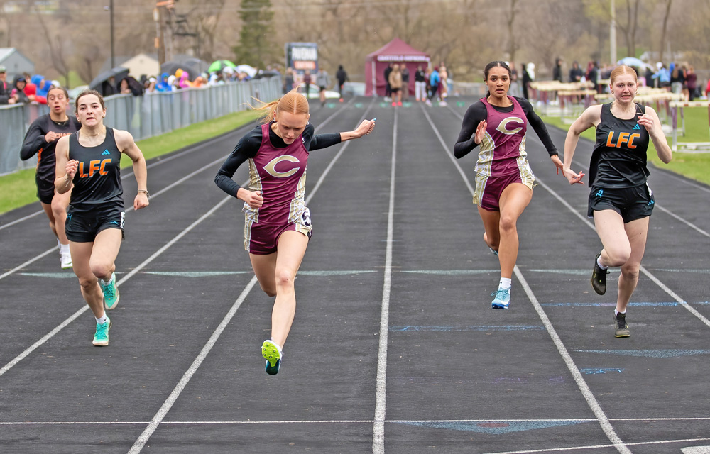 Chatfield’s Jaelyn LaPlante (second from left) crosses the finish line first while competing against teammate Savannah Peterson and LFC’s Charlotte Ferrie (left) and Kinley Soiney (right). LFCMC’s girls won the four-team track and field meet in Chatfield. Photo by Leif Erickson