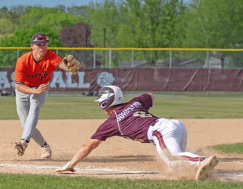 Chatfield’s Chase Johnston dives back into third base safely versus St. Charles’ Brock Decker. The later hit a three-run home run to put the Saints up 9-6 in a key TRC-West baseball game, won by the Saints 10-6, as they claimed the division title (with Chatfield tying for second). Photo by Leif Erickson