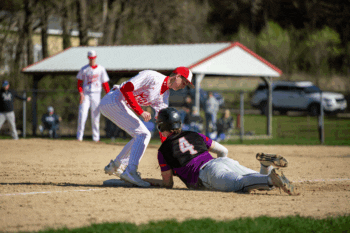 Houston’s C.J. Wruck puts the late tag on GMLOK’s Parker Johnson at third base in the teams’ SEC game, a 9-2 Bulldog win where they swept the season series. Photo by Emma Geiwitz