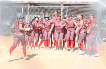 Houston awaits teammate Kylie Stinson at home plate after the 8th grader hit a seventh inning two-run home run to help the Hurricanes top Southland 12-7 in a key SEC matchup. Photo submitted