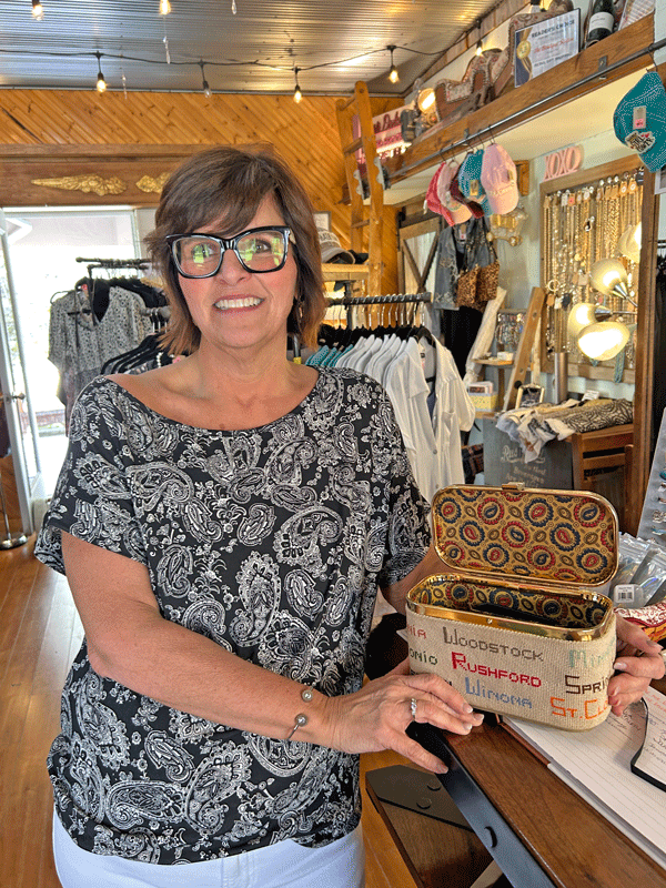 Owner Amy Engelhart displays a hand-needlecrafted purse that she purchased at an antique store in La Crosse long before she decided to open Boutique Station. Coincidentally, the original owner of the purse lived just down the block from where Amy now lives on Steven’s Avenue in Rushford. Amy enjoys decorating the boutique with antique items.