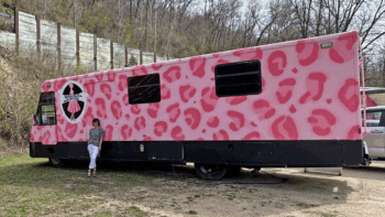 Owner Amy Engelhart poses with the custom painted Winnebago parked at Boutique Station.