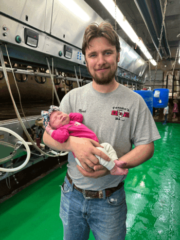 Clara’s first time in a milking parlor with Dad. Photo submitted