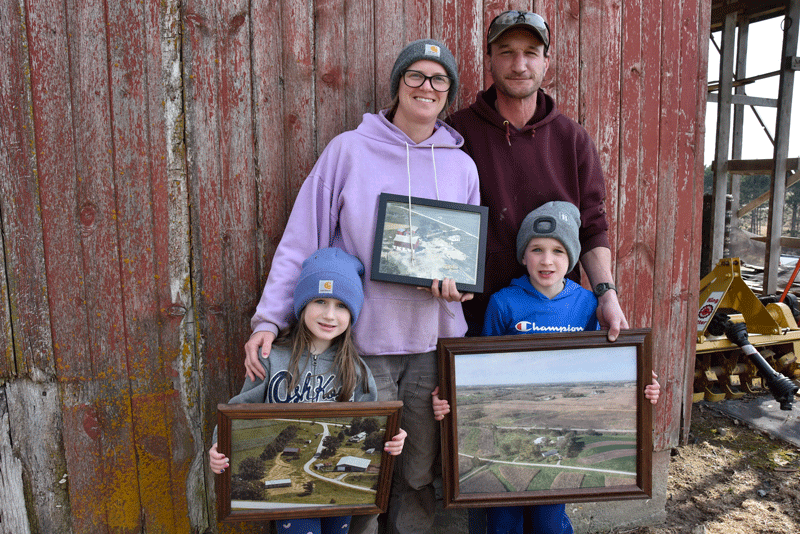 Kristi and Kevin Schuldt and their two young children, Emma and Henry, are continuing the Schuldt family farming tradition. Photo by Charlene Corson Selbee