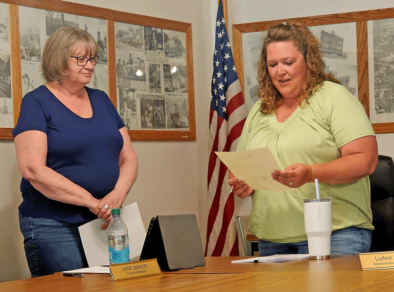 Missy Musel, right, reads the oath of office after being appointed to the Wykoff City Council during the May 12 meeting. City Administrator Becky Schmidt, left, officiated the swearing-in. Photo by Zech Sindt