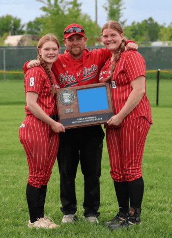 Houston softball’s two seniors, Caitlin Brand and Emily Botcher, plus Head Coach Josh Swenson hold the Section 1A runner-up trophy after the Hurricanes’ excellent 21-5 season. Swenson was the Section’s Coach of the Year, Brand (catcher) and Botcher (pitcher) the team’s all-important battery. Photo by Shannon Boldt